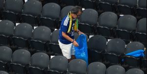 Japanese Fans Cleaning Stadium After Football Match