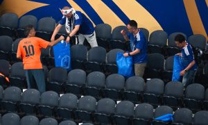Japanese Fans Cleaning Stadium After Football Match